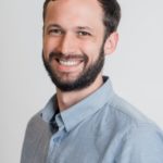 A man called Jon Harris smiling in blue shirt